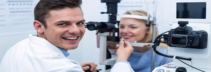 optometrist examing lady with slit lamp