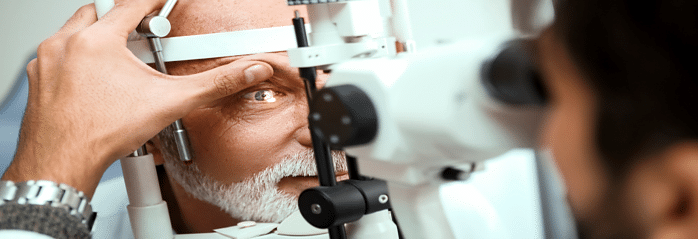 optometrist examing patient with slit lamp